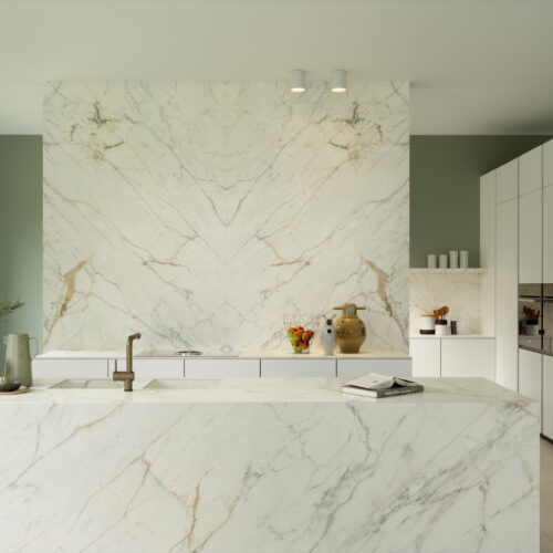 A kitchen with Golden White marble counters and white walls.