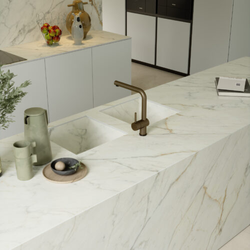 A kitchen with Golden White marble counter tops and a sink.